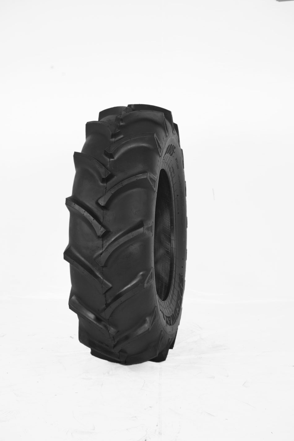 A black heavy-duty agricultural tractor tire with a deep, directional R-1 tread pattern for high traction
