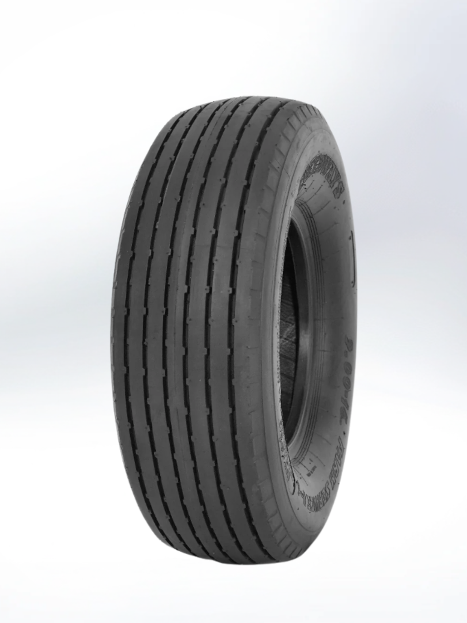 An angled, three-quarter view of a black rubber tire against a plain light gray background. The tire features a specialized tread pattern with multiple deep, parallel vertical grooves running around the circumference, characteristic of a rib tread design typically used for trailers or agricultural equipment. The sidewall shows embossed lettering and technical specifications. Tire, 9.5L-15, PR - 12, Implement, TL, I-1 Pattern
