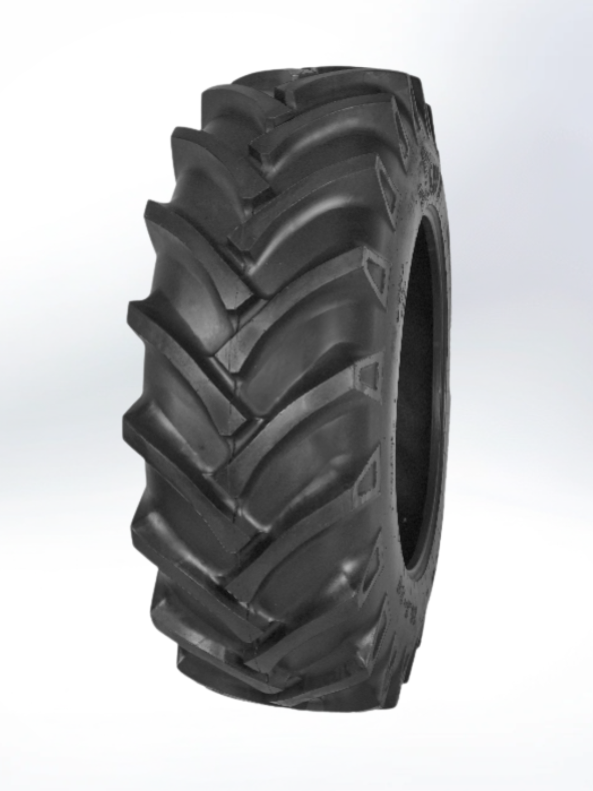 Black agricultural tire with tread pattern on a white background